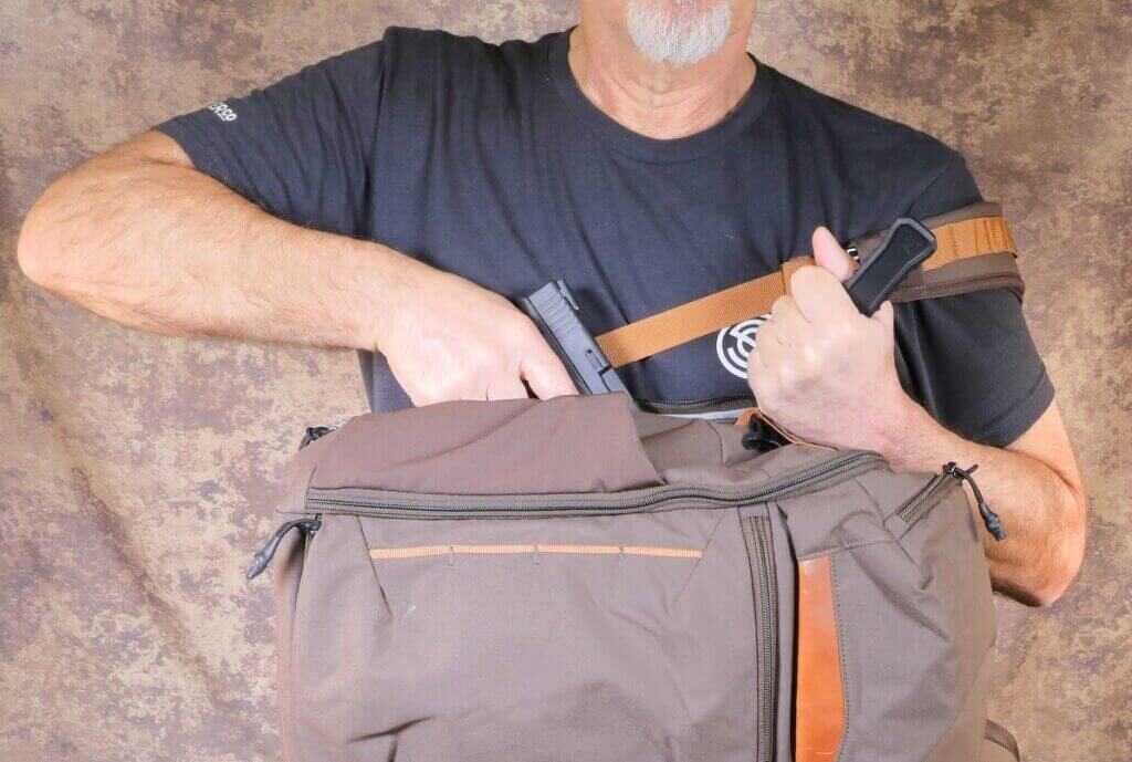Vertyx Gamut concealed carry backpack draw practice with pistol and CrossBreed holster