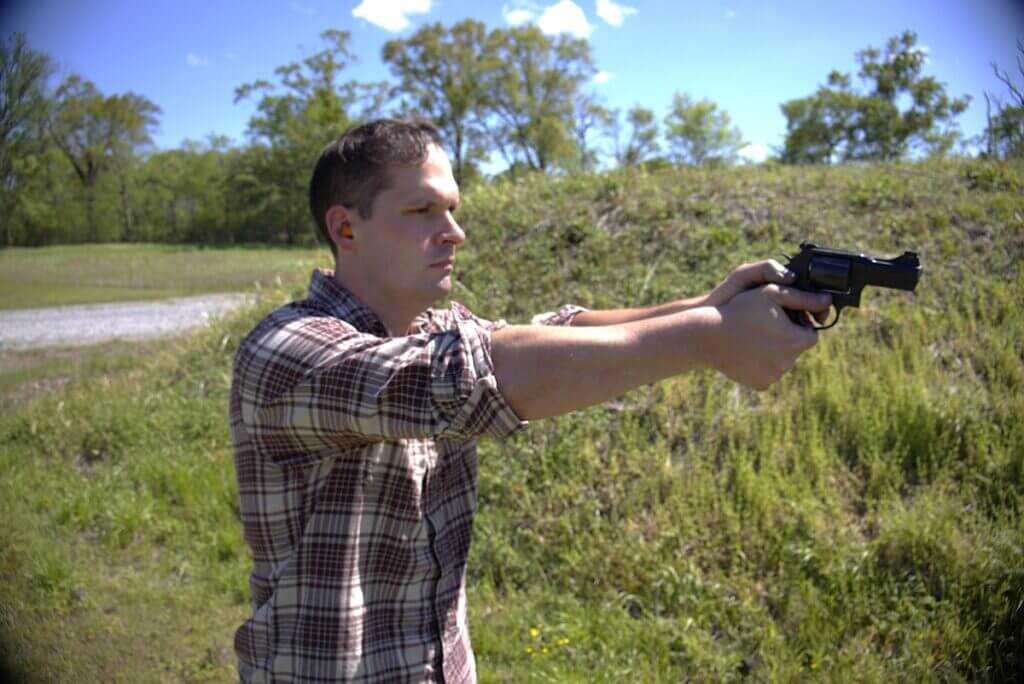 Shooter firing the S&W 396 Night Guard .44 Special revolver on the range