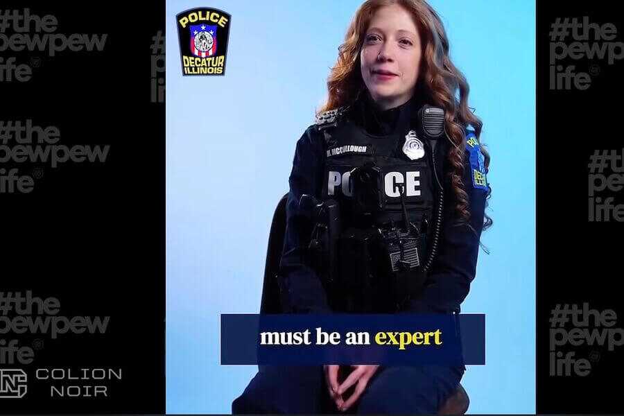 A Decatur, Illinois police officer appears in a recruitment video discussing firearms qualification standards, which Colion Noir critiques in a recent commentary.
