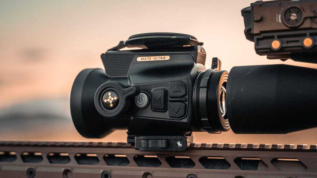 Nocpix MATE Ultra mounted ahead of a conventional riflescope for nighttime long-range shooting