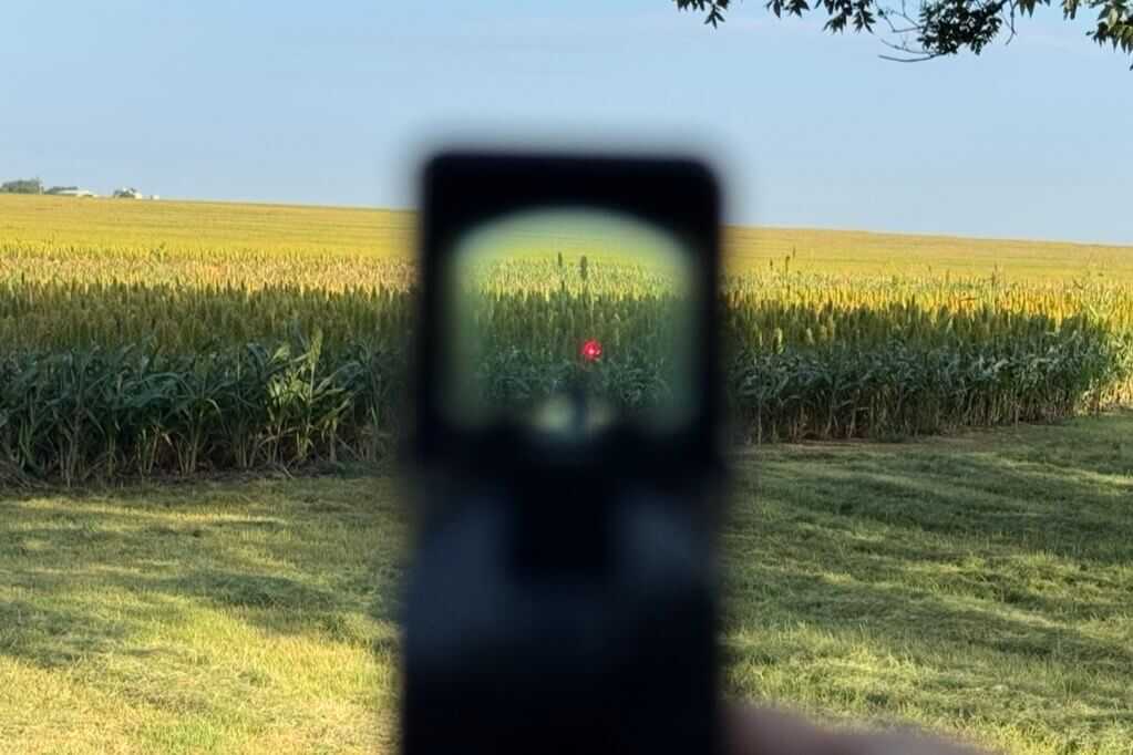 Shooter's view through the Aimpoint COA optic and lower co-witness Prodigy iron sights