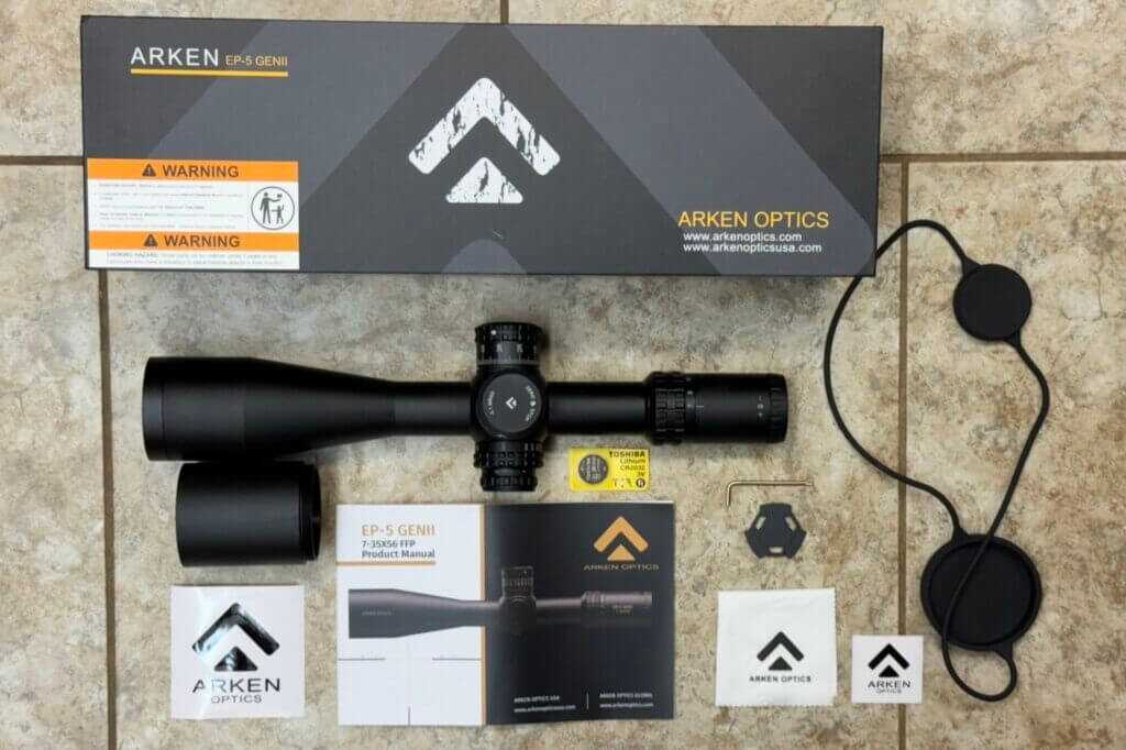 Arken EP-5 GENII scope package with sunshade, lens cover, CR2032 battery, tools, manual, and stickers