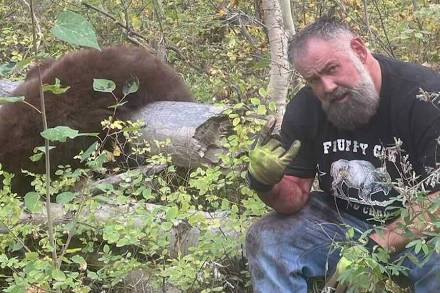 Joelseph Jenkins poses beside an unlawfully harvested black bear during an illegal guiding operation that led to prison time and a lifetime hunting ban in Idaho.