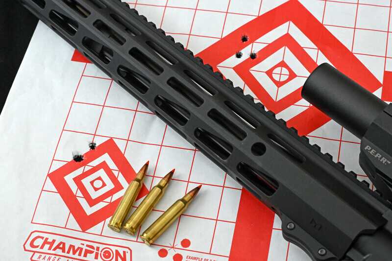 Ruger Harrier AR-15 beside 100-yard target and Hornady 223 Rem ammunition