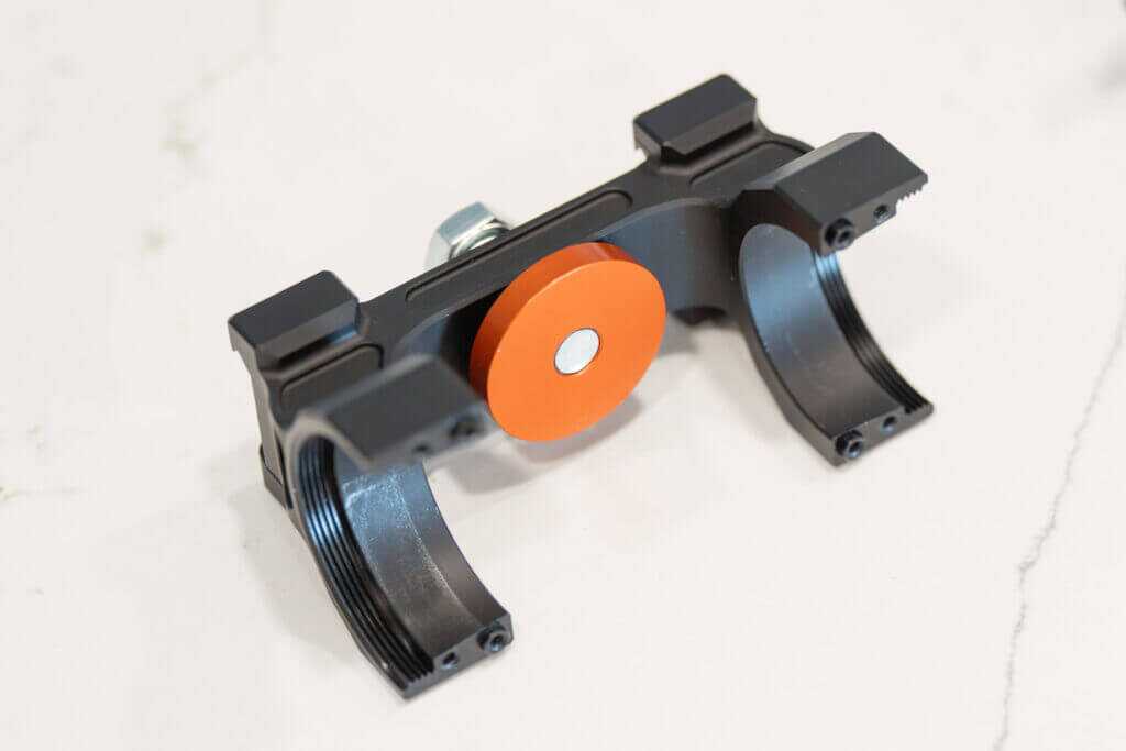 Force 360 leveling screw and pad contacting the underside of a riflescope turret housing