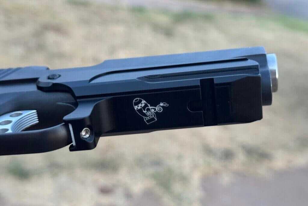 MisterSeven 1911 accessory rail set screw securing the mount against the trigger guard