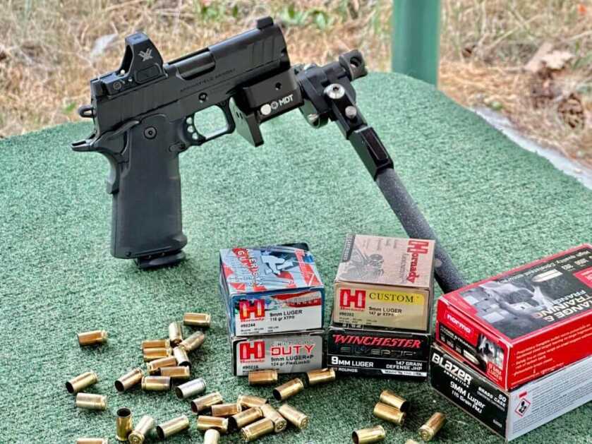 Springfield Prodigy 3.5 AOS accuracy testing from a bench with bipod, rear rest, spent brass, and 9mm ammunition