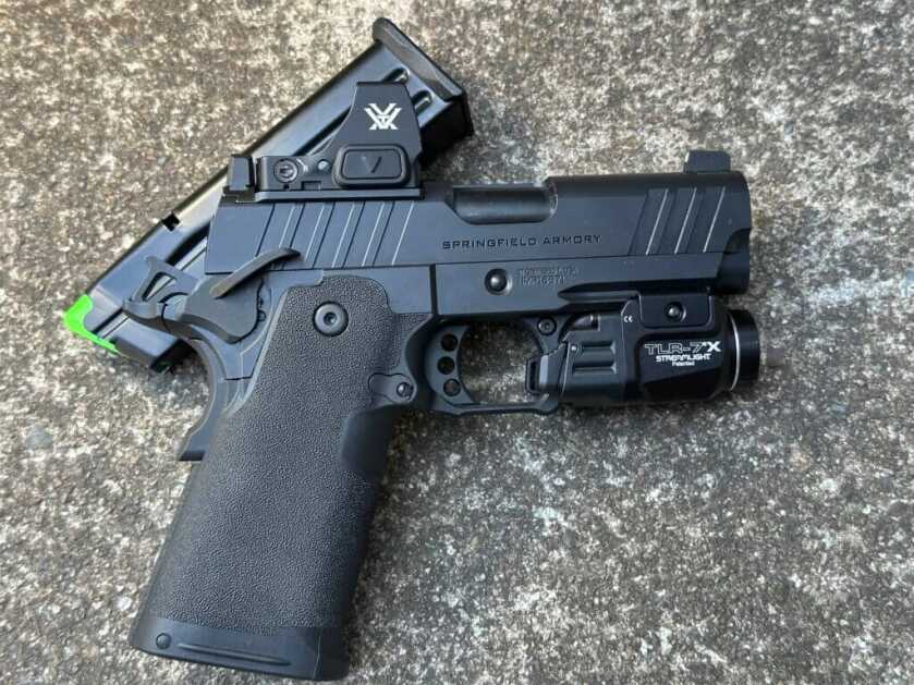 Springfield Prodigy 3.5 AOS on concrete with Streamlight TLR-7 X weapon light installed