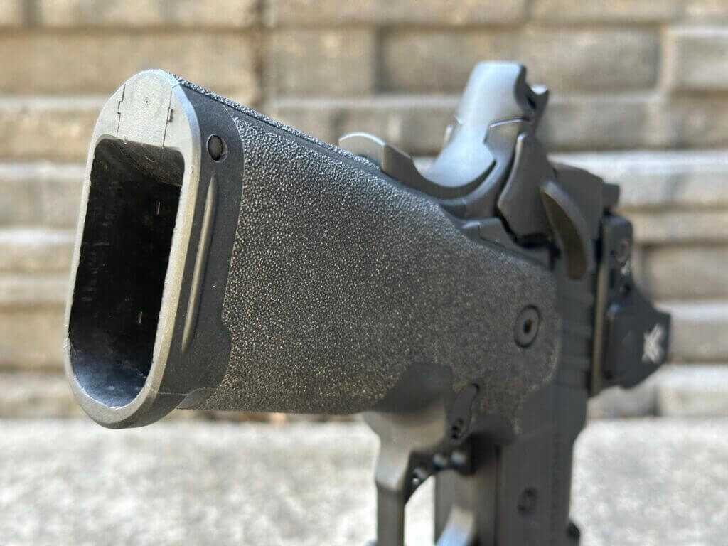 Springfield Prodigy 3.5 AOS grip showing internally flared magazine well and bobbed beavertail