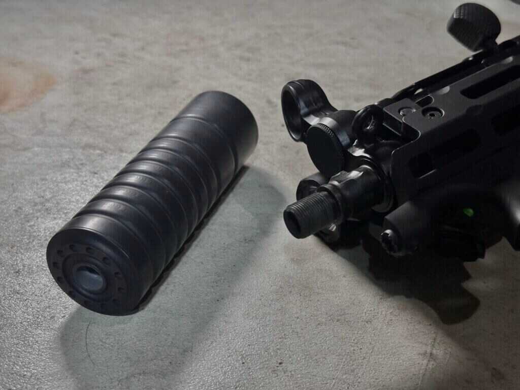 AB Suppressor F4 positioned beside the muzzle of the PTR 9KT MP5K build