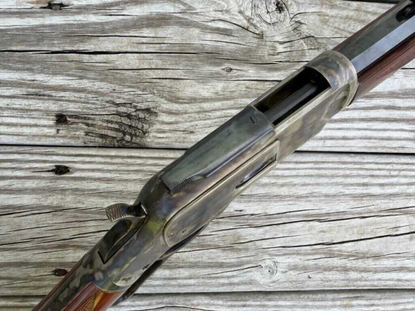Uberti 1873 receiver and sliding dust cover on the toggle-link lever-action rifle