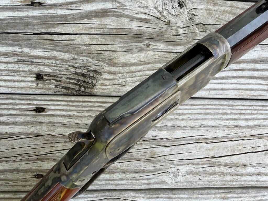 Uberti 1873 receiver and sliding dust cover on the toggle-link lever-action rifle