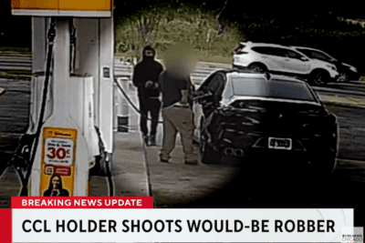 Surveillance image showing a masked person approaching a customer beside an Acura at an Orland Park gas pump.