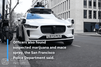 White Jaguar equipped with autonomous-driving sensors on a city street, shown in Colion Noir’s video.