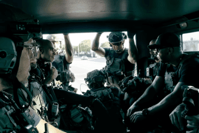 Miami-Dade Sheriff’s Office Special Response Team members prepare inside a tactical vehicle.