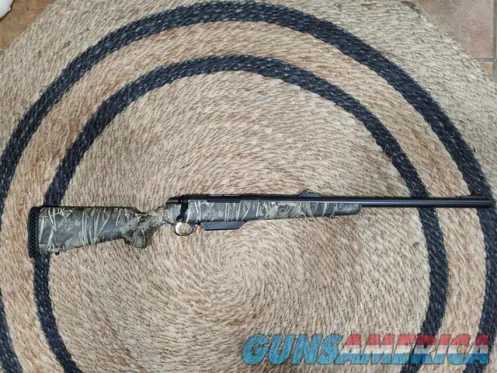 Camo bolt-action hunting rifle with iron...