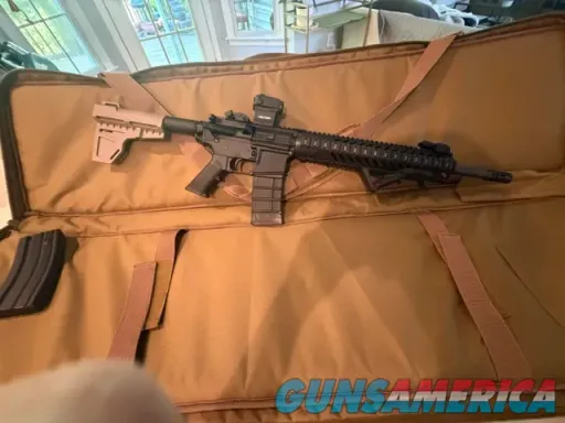 AR-15 carbine with M-LOK rail and red do...