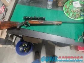 Classic bolt action rifle with wood stoc...