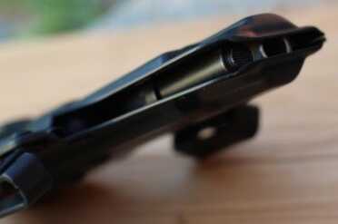 The holster is open on the side, which lets debris out, but may also let debris in.