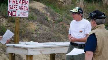 Getting Started in the IDPA Local Match Director, Chuck Limpert gives new shooters a safety and rules orientation. Note that there is a designated area for safe firearm handling.