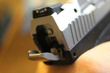 The hammer is a flat paddle that opens up the back of the pistol.