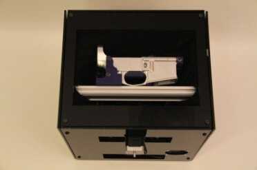 From DD's website: "Ghost Gunner is a miniature CNC machine designed to automatically manufacture publicy created designs with nearly zero user interaction. No prior CNC knowledge or experience is required to manufacture from design files. Defense Distributed's first design is the venerable AR-15 lower receiver. Ghost Gunner automatically finds and aligns your 80% lower receiver to the machine, with simple installation instructions, point and click software and all required tools. Just follow a few simple instructions to mount your 80% lower receiver, tighten a couple screws (with simple tools we provide), and on day one, Ghost Gunner can help you legally manufacture unserialized firearms in the comfort of your own home." (Photo: Defense Distributed)