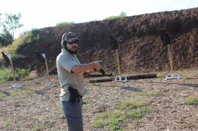 Daniel Shaw demonstrating P226 hammer control while returning pistol to holster