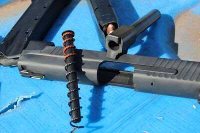 Field-stripped SIG P226 TacOps showing slide barrel spring and frame