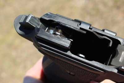 Disassembled SIG P226 showing internal components for cleaning