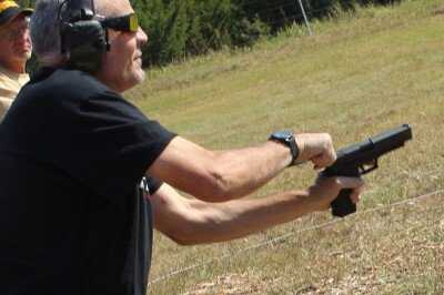 Left-handed shooter handling SIG P226 controls during pistol training