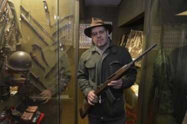 Lynden Museum Director Troy Luginbill holds a Korean War-era M1 carbine Tuesday, Nov. 18, 2014, on loan to the museum. The museum has decided to return the M1 carbine and 10 other loaned weapons to their owners to comply with Initiative 594, which bars loaning guns without a background check. PHILIP A. DWYER — THE BELLINGHAM HERALD 