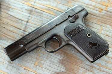 Shooting History: Colt's 1903 Pocket Hammerless--Old Gun Review With the black grips was this the original "black gun"? Note the small safety.