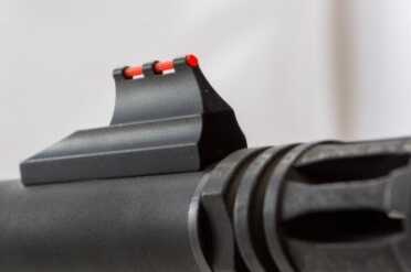 The front sight features a highly visible fiber optic tube. You can easily remove the whole assembly if you like.