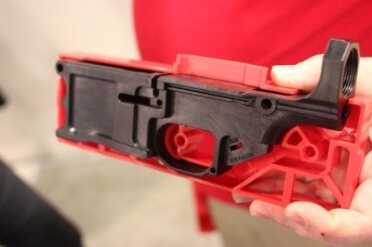 The polymer reacts better, we're told, than some metals. It has more elasticity, and handles recoil energy without cracking. And the jig shows what needs to be removed to make it work.