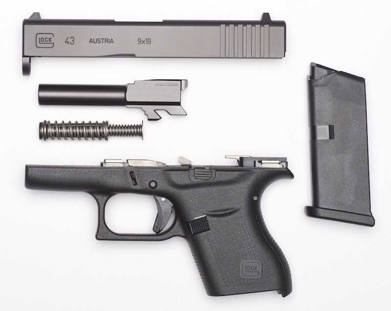 Glock G43 field stripped into slide barrel recoil assembly and Slimline frame
