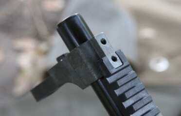 The front sight is rough adjustable, and can be removed if you want to use optics. 