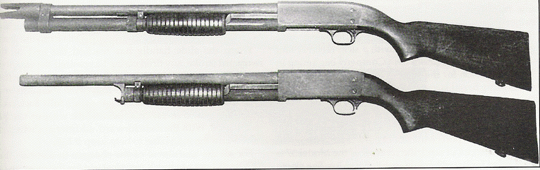 Two Ithaca Model 37s. The one on top is in the military configuration.  You can see why the shot spreader got the duck bill nickname. 