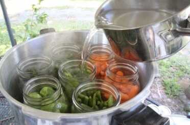 Prepping 101: Rocket Stove Canning For this article I chose cold pack for veggies. The upside is that you don't have to handle hot glass jars, but you lose a lot of capacity per bottle that you can capture if you cook the veggies a little first. For cold pack you cover with boiling water, then stir to remove air bubbles before capping.