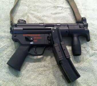 Understanding The HK MP5--Full Auto Review MP5 K Gun with Navy Lower. Factory HK device to attach 2 magazines shown. Factory down front grip to control rise.
