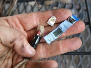 You crack off the tip of the pine pitch shell and the match heads are inside foil and twine. You strike the matches on a little piece of sandpaper in the tape. 