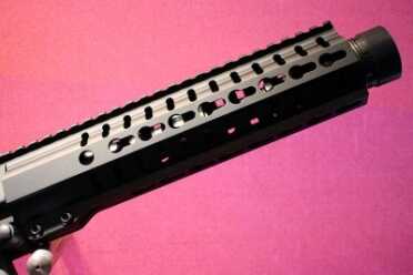 The trim forend hiding the muzzle device. 
