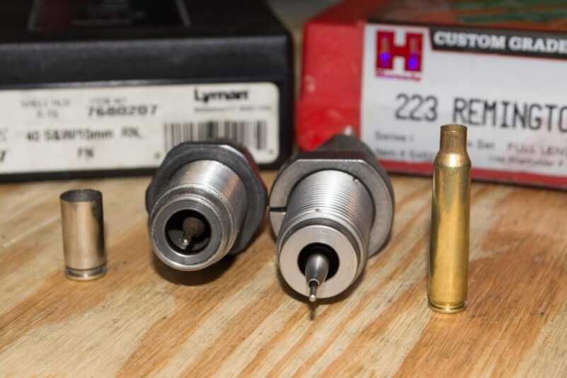 Resizing dies have a pin that knocks the spent primer out from the inside.
