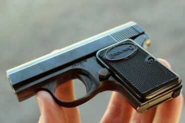 The Baby Browning--a Micro Classic As an import, the gun is covered in stamps.