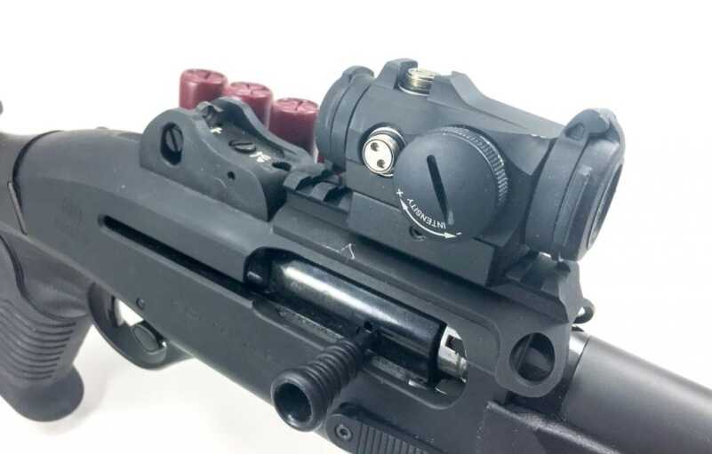 Gear Bag - Tactical Shotgun Accessories The Aimpoint Micro H-2 is attached with a quick-detach mount, so if it pukes the iron ghost ring sights are there and ready.