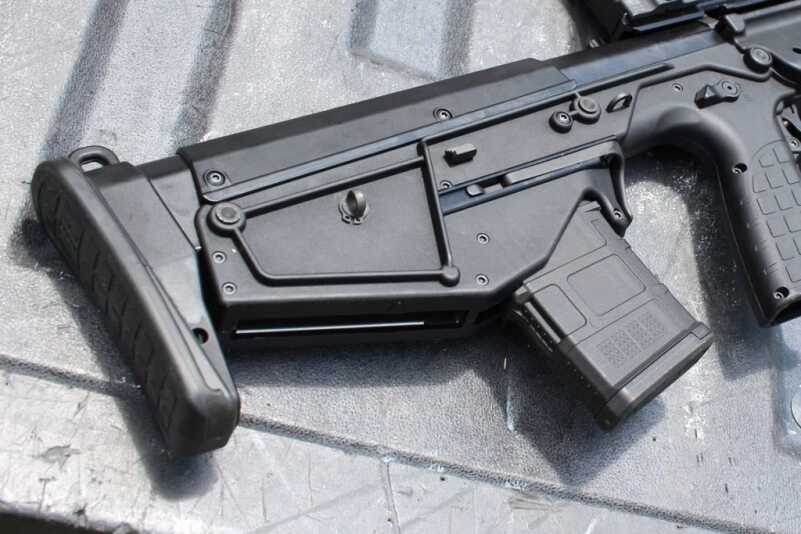 The rounds eject from the gap here between the butt and the magazine.