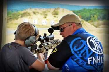 Kids And Guns: Teach Your Children Well FN USA's Tabor Bright, working with a junior shooter at a side match event. Side matches are events incorporated into competitions, designed to both showcase guns and introduce new shooters in a friendly, one-on-one environment.