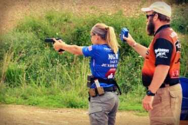 Kids And Guns: Teach Your Children Well Dean DeTurk, instructing at the MGM Junior camp while Katie Francis shoots pistol.
