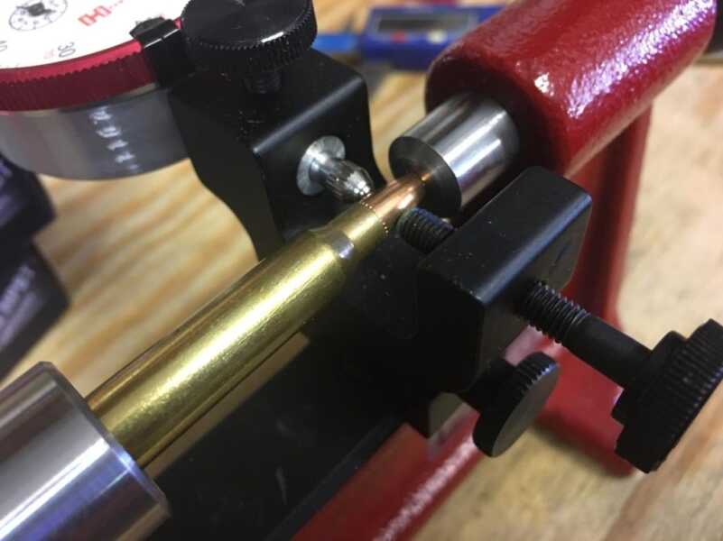 The silver probe on the left measures variance while the thumbscrew on the right allows you to make corrections. 
