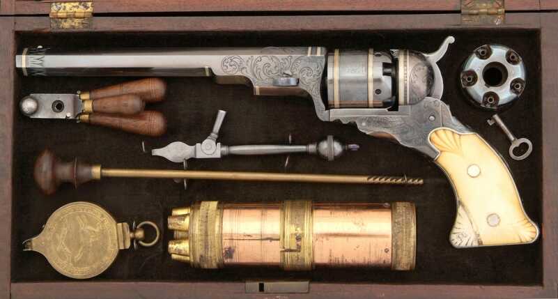 An early Texas Paterson (No. 5 Holster Model) features scroll engraving and border engraving, silver inlaid bands on the barrel, cylinder, and frame. The early models did not have the loading lever mounted under the barrel and hand to be disassembled (barrel and cylinder removed) in order or reload, or change out an empty cylinder for a loaded one. The guns always came with two cylinders. (Dennis Levett collection).