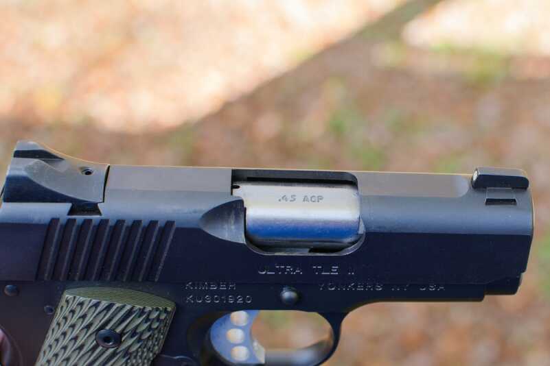 The pistol features a flattop slide and factory night sights. 